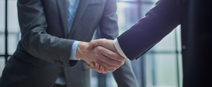 business men shaking hands after making a deal